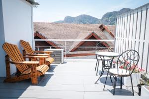 a patio with chairs and tables on a balcony at Phi Phi Indigo Hotel in Phi Phi Islands