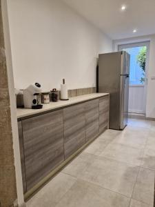 a kitchen with a stainless steel refrigerator at La place in Pont-de-Vaux