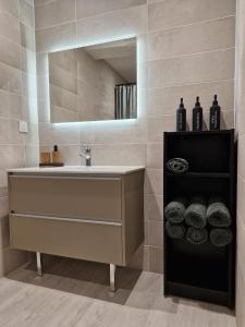a bathroom with a sink and a mirror at La place in Pont-de-Vaux