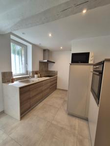 a kitchen with a refrigerator and a sink at La place in Pont-de-Vaux