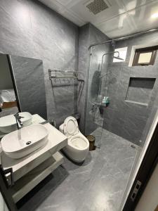 a bathroom with a shower and a toilet and a sink at Tam Coc Sunflower Hotel in Ninh Binh
