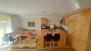 a kitchen with a table and a dining room at Podlugovi House Villa in Podlugovi