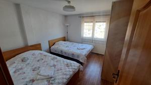 a bedroom with two beds and a window at Podlugovi House Villa in Podlugovi