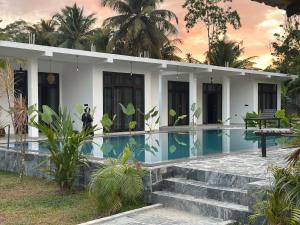 a house with a swimming pool in front of it at Era 25 in Ahangama