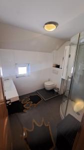 a small bathroom with a toilet and a window at Podlugovi House Villa in Podlugovi