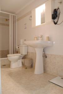 a bathroom with a sink and a toilet at Sweet Suites in Amalias +20 photos