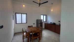 a kitchen and dining room with a table and chairs at Era 25 in Ahangama