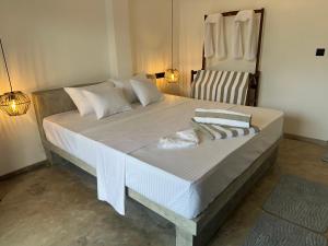 a large bed in a room with a chair at Era 25 in Ahangama +32 photos