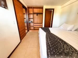 a small bedroom with a bed and a tiled floor at Kariri beach apt 427 Praia do Cumbuco in Cumbuco +9 photos
