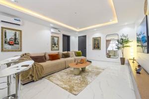 a living room with a couch and a table at Mex 1 bedrooms Lekki phase1 in Lagos