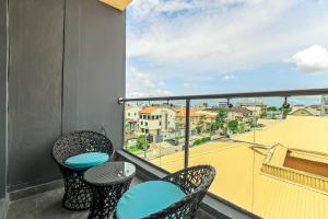 a balcony with two chairs and a view of a city at Mex 1 bedrooms Lekki phase1 in Lagos