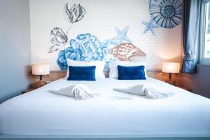 a white bed with two pillows on top of it at Phi Phi Indigo Hotel in Phi Phi Islands
