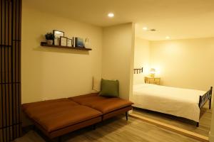 a bedroom with a bed and a couch in a room at ION House - Near Shopping Kennedy Station Easy Transit Downtown in Toronto