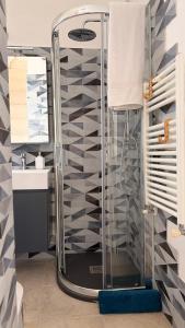 a shower in a bathroom with a sink and a glass shower at Lumia - Casa Vacanze in Martina Franca