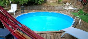 a swimming pool in a hammock in a yard at Chico's loc in Sainte-Luce