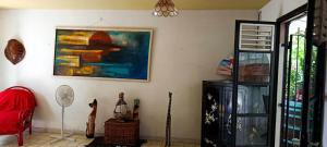 a living room with a painting on the wall at Chico's loc in Sainte-Luce
