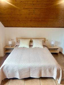 a bedroom with a large white bed with two lamps at LS Alojamiento Turístico in Arcade