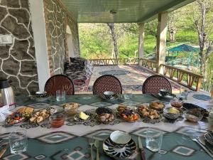 a table with food on it on a porch at Muso guesthouse in Yukary-Ukhum