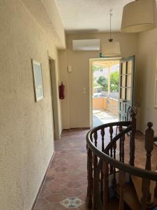 a hallway with a staircase leading to a door at PALIO LIMANI HOUSE in Spetses