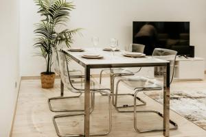 a dining room with a table and chairs with wine glasses at Alta de Faro in Faro