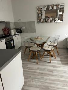 a kitchen with a table and chairs in a room at ApartmanJ&K in Kiseljak