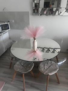 a table with a pink feather on top of it at ApartmanJ&K in Kiseljak