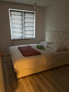 a bedroom with a large bed with a window at ApartmanJ&K in Kiseljak