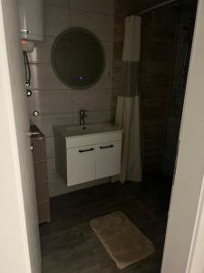 a bathroom with a sink and a mirror at ApartmanJ&K in Kiseljak
