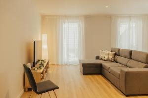 a living room with a couch and a chair at Termas do Gerês Studio in Geres