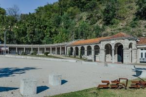 a large building with benches in front of it at Termas do Gerês Studio in Geres