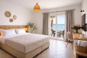 a bedroom with a bed and a view of the ocean at Nel Mare Studios in Laganas