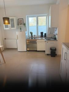 a kitchen with a white refrigerator and a stove at Landglück in Ibbenbüren