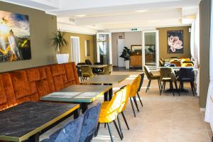 a restaurant with tables and chairs and a dining room at Hotel Restaurant Blumenhof in Baesweiler