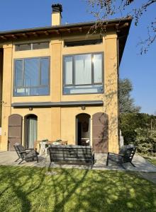 a house with two chairs on a patio at Casa Barovaldo in Zola Predosa