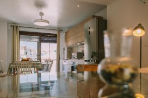 a kitchen with a dining table and a refrigerator at Casa Aula Minerva Lumen 3 Dormitorios in Almedinilla