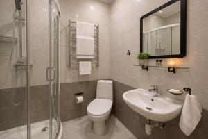 a bathroom with a sink and a toilet and a shower at Gusarskiy Hotel and Apartment in Kyiv +50 photos