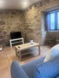 a living room with a couch and a coffee table at LS Alojamiento Turístico in Arcade