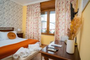 a hotel room with a bed and a table with a night stand at Joy's Rooms Ortigia in Syracuse