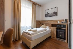 a hotel room with a bed and a television at Hotel Residence in Würzburg +61 photos