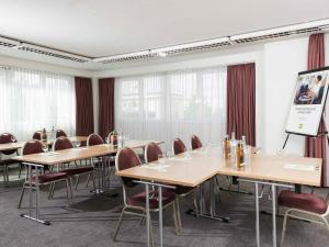 a conference room with wooden tables and chairs at ibis Styles Halle in Halle an der Saale