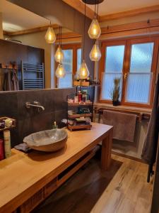 a bathroom with a stone sink on a wooden table at Ferienwohnung Ehring in Kiefersfelden +10 photos