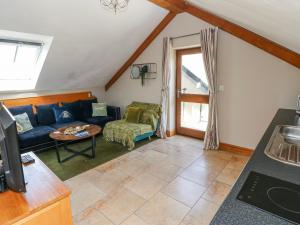 a living room with a couch and a table at Willow Apartment - Gower in Swansea +38 photos