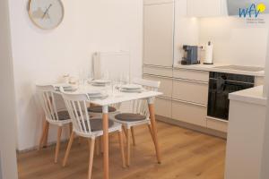 a kitchen with a table and chairs in a kitchen at Stine's Hus Ferienwohnung 2 in Borkum