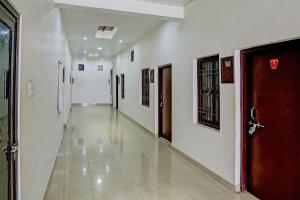 an empty hallway of a hospital with a door at Hotel O The Raghav Villa in Prayagraj