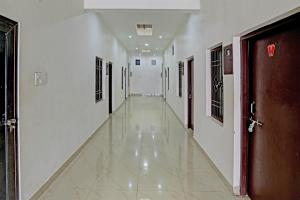 an empty corridor in a hospital with a door and a hallway at Hotel O The Raghav Villa in Prayagraj