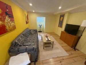 a living room with a bed and a tv at Rossio Downtown in Lisbon