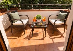 a patio with two chairs and a table with two candles at Stella Marina Sea & Sun in Cefalù +35 photos