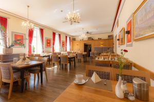 a dining room with tables and chairs in a restaurant at Hotel Residence in Würzburg