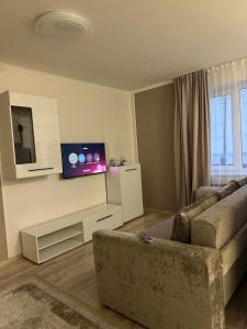 a living room with a couch and a flat screen tv at Апартаменти студія in Truskavets
