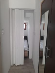 a hallway with a room with a bed and a mirror at Goga2 in Pirovac